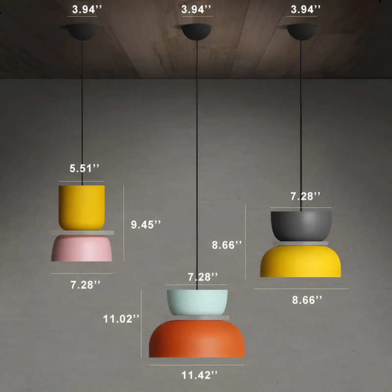 Drei bunte, moderne Pendelleuchten, gelb, grau, orange, mit Maßen, hängend an Holzdecke.