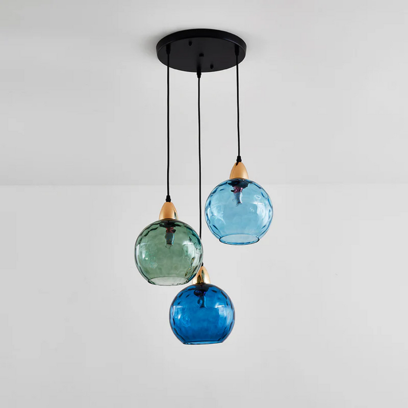 Dreifache Pendelleuchte, bunte Glaslampen, modernes Design, schwarze Deckenhalterung.