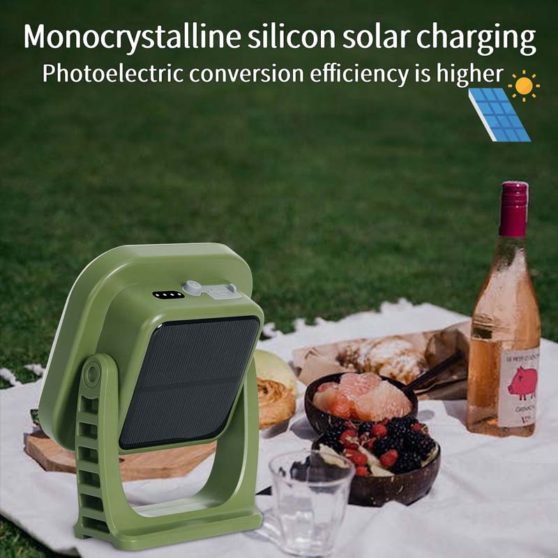 Grünes monokristallines Solarladegerät auf Picknickdecke mit Essen und Getränken.