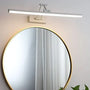 Runder Spiegel mit goldfarbenem Rand und moderner LED-Wandleuchte in minimalistischem Design.