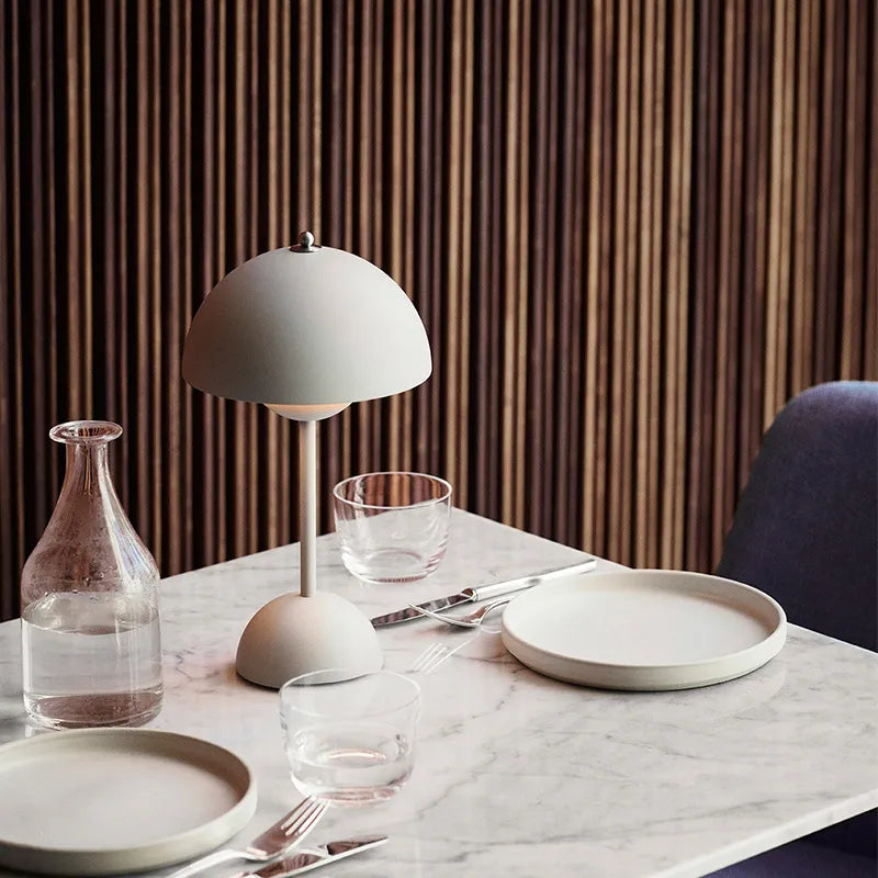 Moderne Tischlampe auf Marmortisch mit Geschirr, skandinavisches Design, minimalistisch.