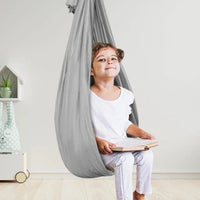 Kinderschaukel Indoor, grau, mit Kind, therapeutisch, hängend, für Zuhause, Entspannung.