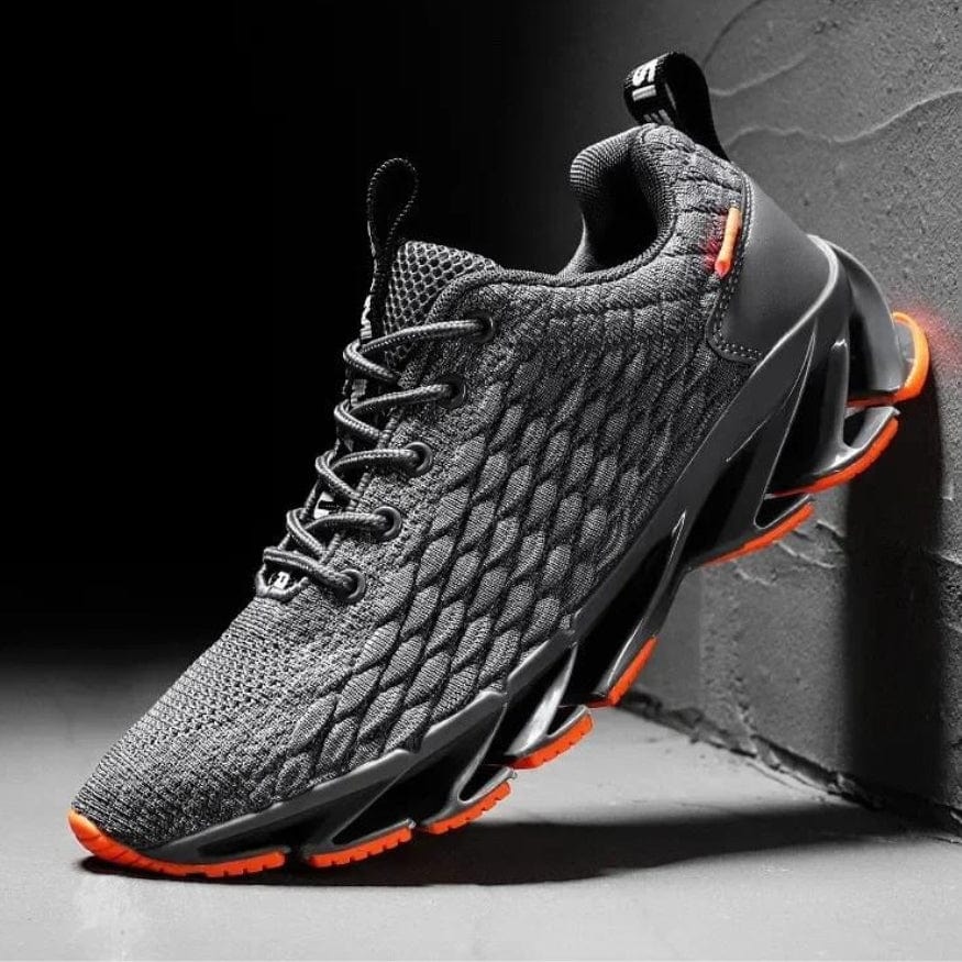 Grauer Sportschuh mit orangen Akzenten, atmungsaktives Mesh, rutschfeste Sohle, Herren Sneaker.