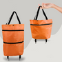 Orange faltbare Einkaufstasche mit schwarzen Griffen, leicht, tragbar, ideal für Einkäufe.