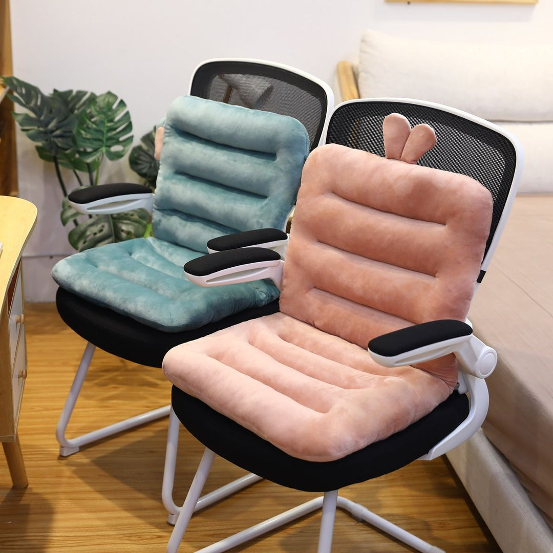 Zwei ergonomische Bürostühle mit weichen, pastellfarbenen Sitzkissen in Rosa und Blau.