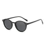 Schwarze runde Sonnenbrille, Unisex, UV-Schutz, modisches Accessoire, Kunststoffrahmen.