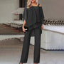 Elegantes schwarzes Damen-Outfit, zweiteilig, schulterfrei, ideal für Abendveranstaltungen.