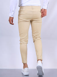 Mann in beigen Chinos und weißem Hemd, Rückansicht, modische Herrenbekleidung, Freizeitlook.