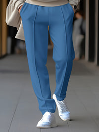 Blaue Damenhose, elegant, mit Bügelfalte, kombiniert mit weißen Sneakers, modisch, streetwear.