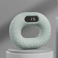 Grüner digitaler Fitnessring mit Display, ergonomisches Design, Heimtraining, Sportgerät.