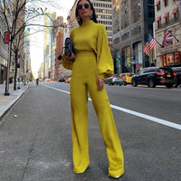 Frau in gelbem Jumpsuit auf Stadtstraße, modisch, elegantes Outfit, urbane Mode.