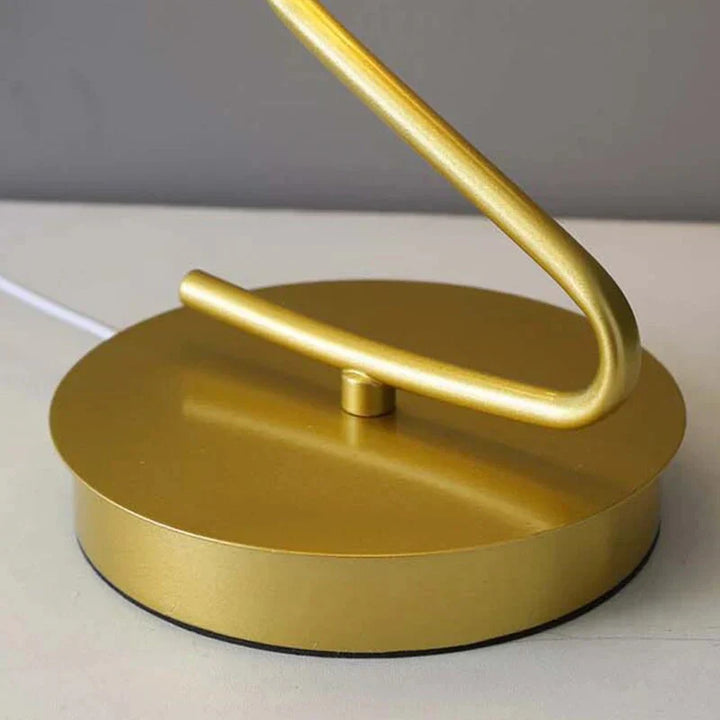 Goldene Tischlampe, modernes Design, Metall, runder Sockel, elegante Beleuchtung, Inneneinrichtung.