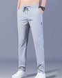 Graue Herren-Sporthose, atmungsaktiv, mit Kordelzug, ideal für Fitness und Freizeit.