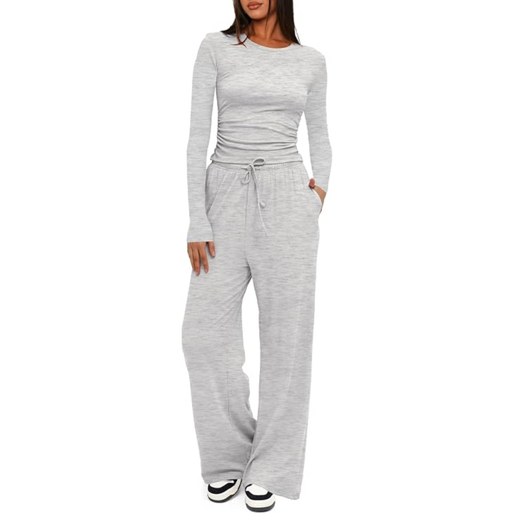 Frau in grauem, langärmligem Jogginganzug, bequem, modisch, Freizeitkleidung, Damenmode.