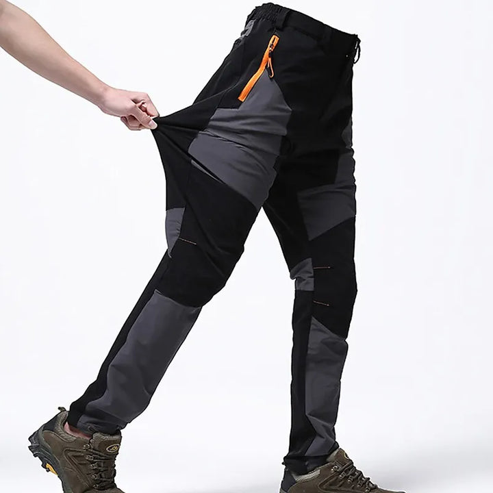Wasserdichte Outdoor-Hose, schwarz-grau, elastisch, mit Reißverschlusstasche, für Herren.