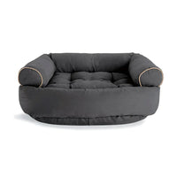 Graues Hundebett aus Stoff mit erhöhten Seiten, bequemes Design, ideal für mittelgroße Hunde.