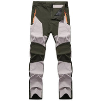 Wasserdichte Outdoor-Hose, grün-grau, mit Reißverschlusstaschen, ideal für Wandern und Trekking.
