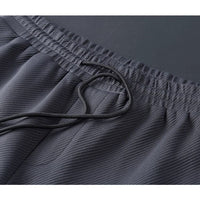 Dunkelgraue Premium-Trainingshose, hochwertige Materialien, elastischer Bund, Kordelzug.